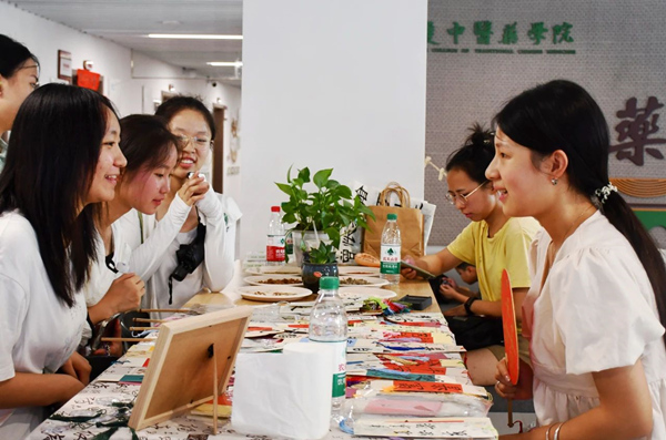 中药学院迎新现场，新生和家长们对各种中草药文创产品兴趣浓厚。bat365中文官方网站供图